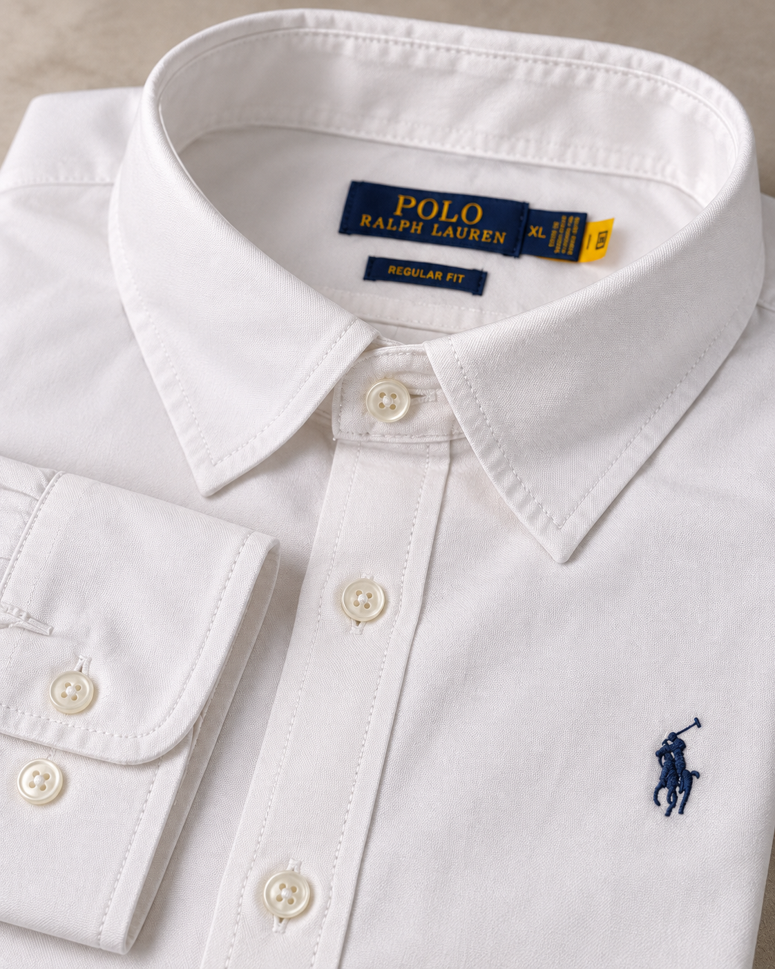 Button-down collar and stitching detail on the white Oxford shirt