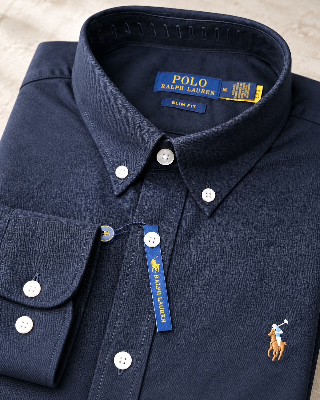 Button-down collar and stitching detail on the navy Oxford shirt