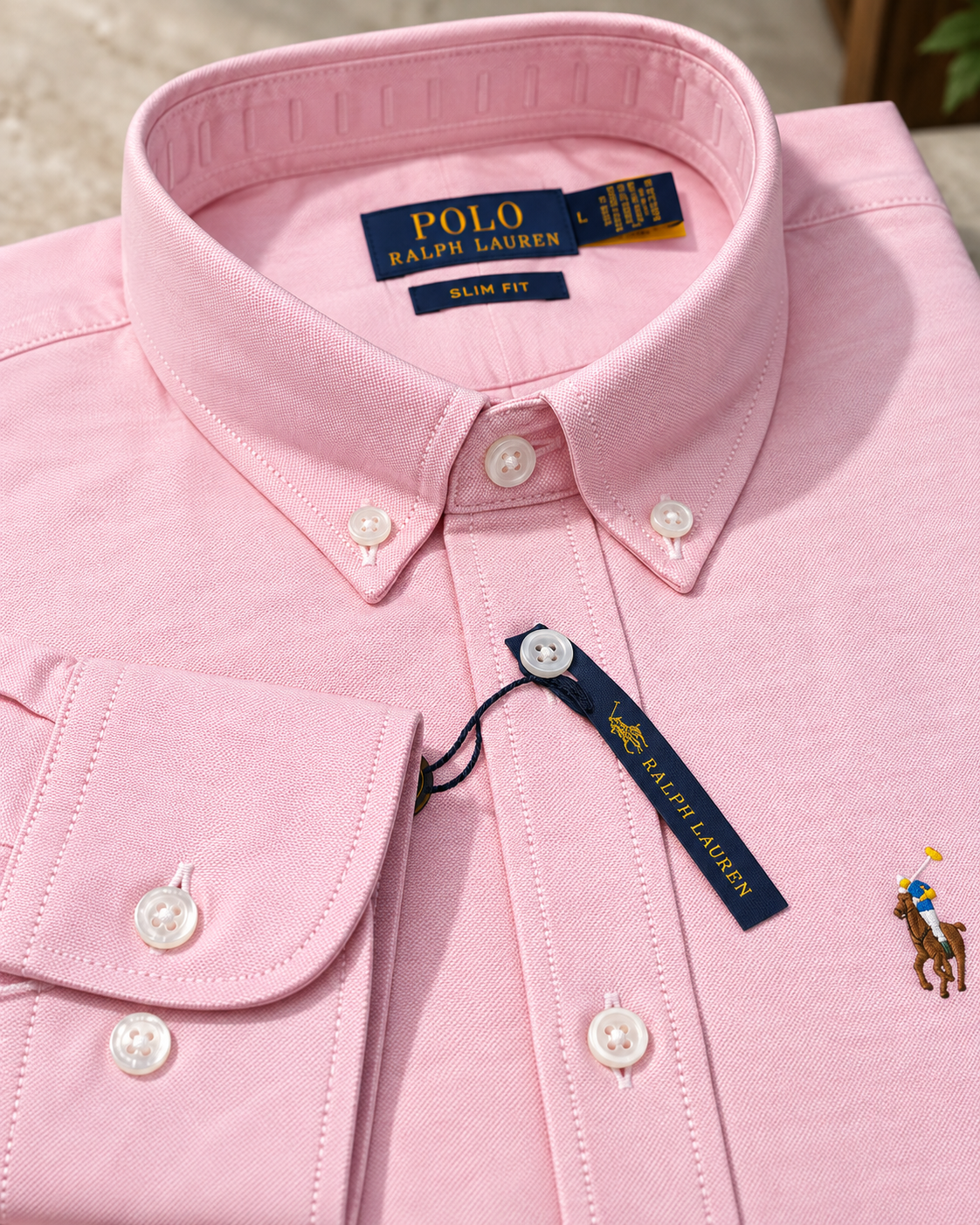 Button-down collar and stitching detail on the pink Oxford shirt